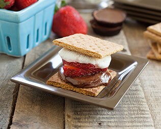 Jelly filled smore on silver plate on a wooden table