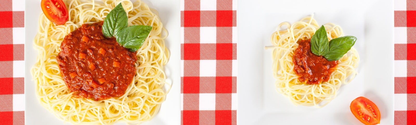 One plate with a large serving of spaghetti next to one plate with a smaller serving of spaghetti