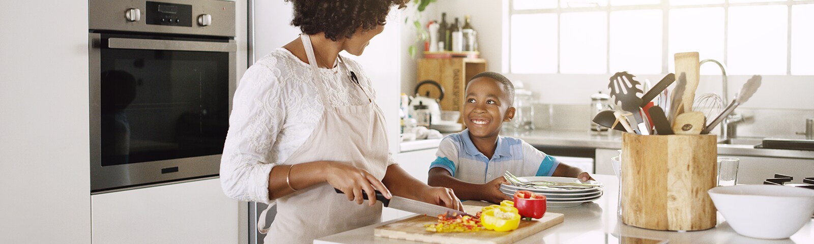 Mother and son cooking dinner together