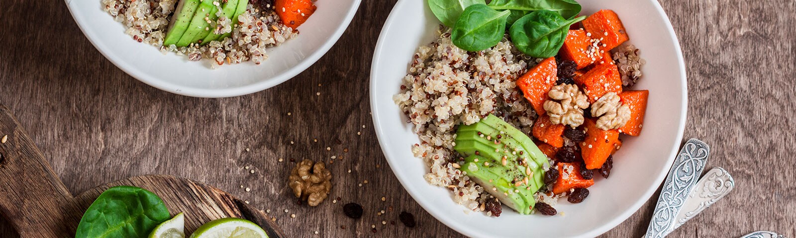 Quinoa bowls with avocado on a wooden table Quinoa bowls with avocado on a wooden table