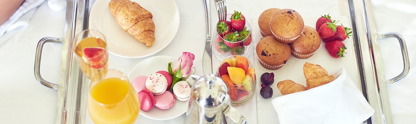 Mom’s breakfast in bed on a tray with flower arrangement